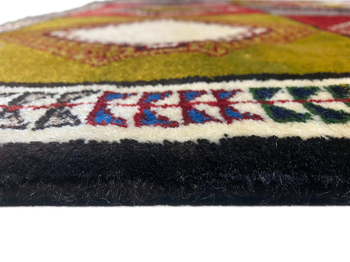 Teppichkante mit Musterbordüre und hohem Flor, seitliche Abschlusswicklung sichtbar